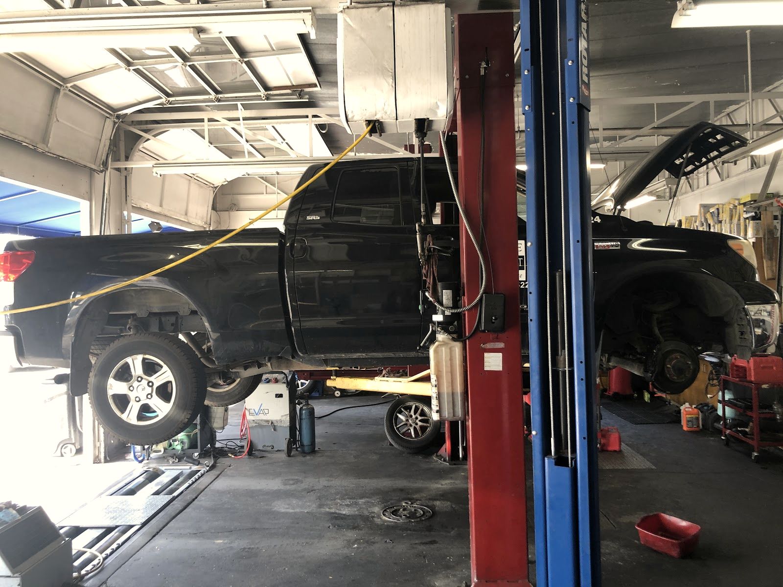 A truck up on the lift inside LGB Auto